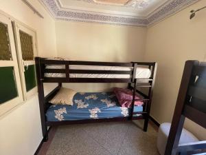a bedroom with two bunk beds in a room at Mavi Surf Stay Tamraght in Tamraght Ouzdar +6 photos