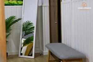 a chair and a mirror in a room at Casa dos Passos 1 in Guarda