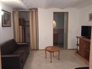 a living room with a couch and a table at Gîte Le Pic Epeiche in Saint-Roman