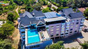 an aerial view of a large house with a swimming pool at Ngolu Hotel and Residences in Kitui