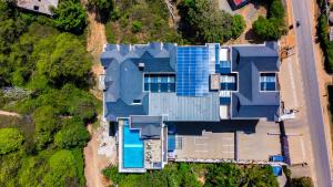 an overhead view of a blue house with a swimming pool at Ngolu Hotel and Residences in Kitui