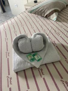 a towel in the shape of a heart on a bed at Hotel São Mateus in São Paulo