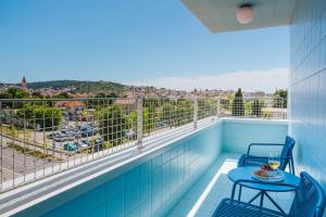a balcony with a table and chairs and a view at áPero Suites in Trogir