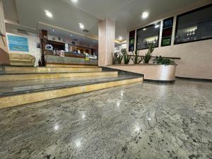 a lobby with stairs and a bar in a building at Hotel Acquario in Campomarino