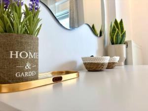 a table with a home and garden bag and plants at Andreana's Place Rhodes in Asgourou