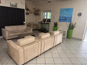 a living room with two couches and a table at Hotel Acquario in Campomarino