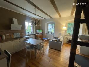 a kitchen and dining room with a table and chairs at Ferienwohnung "Altes Schloss Wilhelmsfeld" in Eselsberg
