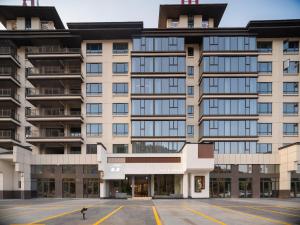 a rendering of the exterior of a building at Zhangjiajie Utopia Hotel-New Hotel,English Speaking Host,Free Shuttle Service to East Gate of forest park,Free Fresh Coffee&Tea,Free Self-Service Laundry & Drying, Super-Large Swimming Pool,Tourism Service, Family and Group-friendly in Zhangjiajie