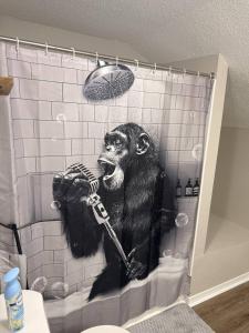 a painting of a gorilla in a shower at 2 King Suites w/ Private Baths + Workspaces | LSU in Baton Rouge +24 photos