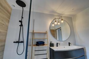 a bathroom with a sink and a mirror at Maison de Charme avec Spa Privatif & Jardin en Pleine Nature - Plages à moins de 20min in Guerlesquin +30 photos