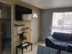 a small room with a bed and a television at Casa Cartagena in Zamora de Hidalgo