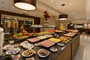 a buffet line with many different types of food at Lapidare Flat Hotel Comfor Alphaville até 4 pessoas in Barueri