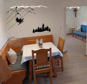 a dining room with a table and a table and chairs at Ferienwohnung Kollerlehen in Bischofswiesen