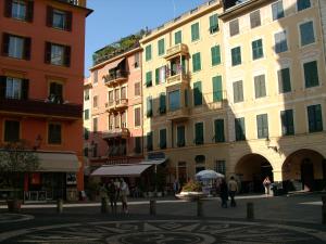 a group of buildings with people standing in a street at LHP Suite Santa Margherita in Santa Margherita Ligure
