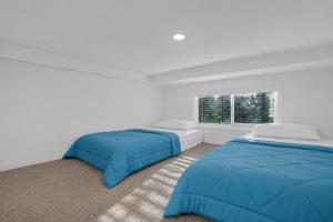 a bedroom with two beds and a window at Tiny Blue at Yosemite Gateway in Groveland