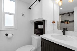 a white bathroom with a sink and a toilet at Tiny Blue at Yosemite Gateway in Groveland +19 photos