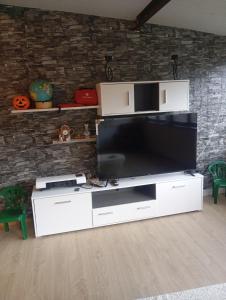 a large entertainment center with a large flat screen tv at O cantinho d'abelheira in Falgueiras