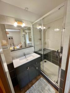 a bathroom with a sink and a shower at L'Escale d'Armorique 1 in Languidic