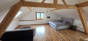 a attic bedroom with a bed and a couch at La Rochetta in Chatel sur Montsalvens