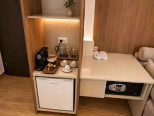 a small kitchen with a counter and a microwave at Morfeas City Hotel in Rhodes Town