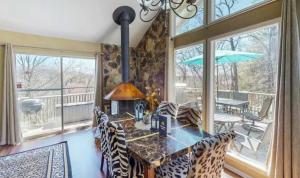 a dining room with a table and chairs and a balcony at The Safari Lodge in Osage Beach