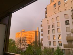 a view of two buildings from a window at Chambre privée dans un appartement en colocation, parking gratuit in Bagneux