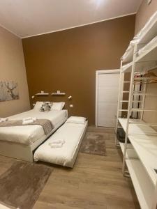 a bedroom with two beds and a book shelf at Mado Suite 112 in Bari