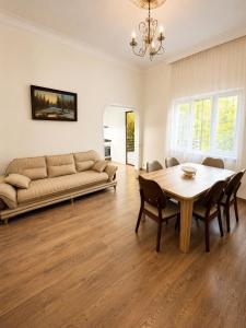 a living room with a table and a couch at Green Garden in Batumi