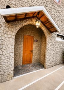 a door to a building with a stone wall at Green Garden in Batumi