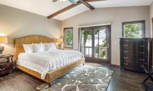a bedroom with a bed and a large window at Unforgettable Lake Memories in Lake Ozark