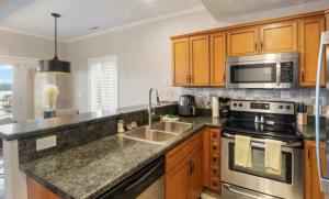 a kitchen with a sink and a stove at Emerald Bay Unit 1B in Lake Ozark