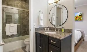 a bathroom with a sink and a toilet and a mirror at Emerald Bay Unit 1B in Lake Ozark