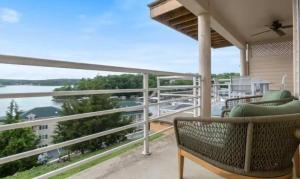 a balcony with chairs and a view of the water at Emerald Bay Unit 1B in Lake Ozark