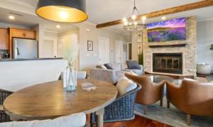 a living room with a table and chairs and a fireplace at Emerald Bay Unit 1B in Lake Ozark