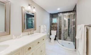 a bathroom with two sinks and a shower and a toilet at Lake Ozarks in Rocky Mount
