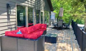 a red couch sitting on a screened in porch at Lake Ozarks in Rocky Mount