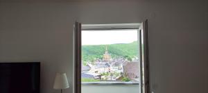 an open window with a view of a city at Le Point Relais in Fumay