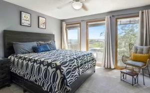 a bedroom with a black and white bed and a window at Full Moon Condo in Lake Ozark