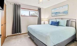 a bedroom with a large bed and a window at Full Moon Condo in Lake Ozark +23 photos
