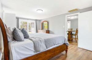 a bedroom with a large bed with white sheets at Eternal Sunrises in Sunrise Beach