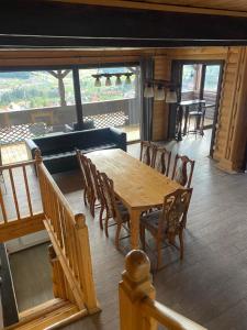a wooden table and chairs in a living room at Chalet Trushnyi in Palyanytsya