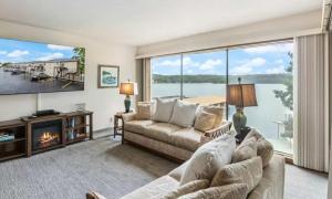 a living room with a couch and a large window at Pelican Bay Getaway in Lake Ozark