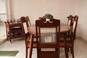 a dining room table and chairs with a plant on top at Casa Bedz, alberca privada in Campeche