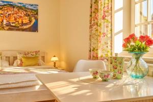a room with a table with a vase of flowers on it at Villa Harmony in Český Krumlov