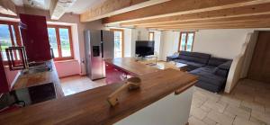 a kitchen and living room with a couch and a counter at La Rochetta in Chatel sur Montsalvens