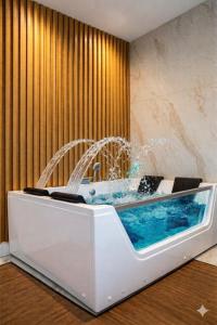 a bath tub with a fountain in a room at Partenopeo Rooms & Suite in Nola