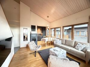 a living room with a couch and chairs and a fireplace at Ruka Center Chalet 3B4 - Ski-In Ski-Out - All services nearby - AC - Fireplace - Wifi - Own parking place in Ruka