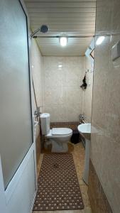 a bathroom with a toilet and a sink at Daniel SAMARKAND in Samarkand +18 photos