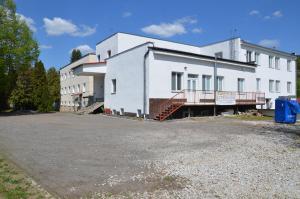 a white building with a parking lot in front of it at JOPEL ubytovanie v súkromí in Slovenské ďrmoty