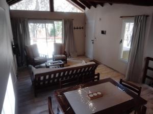 a living room with a table and chairs and a dining room at Bosque y Mar in Mar Azul